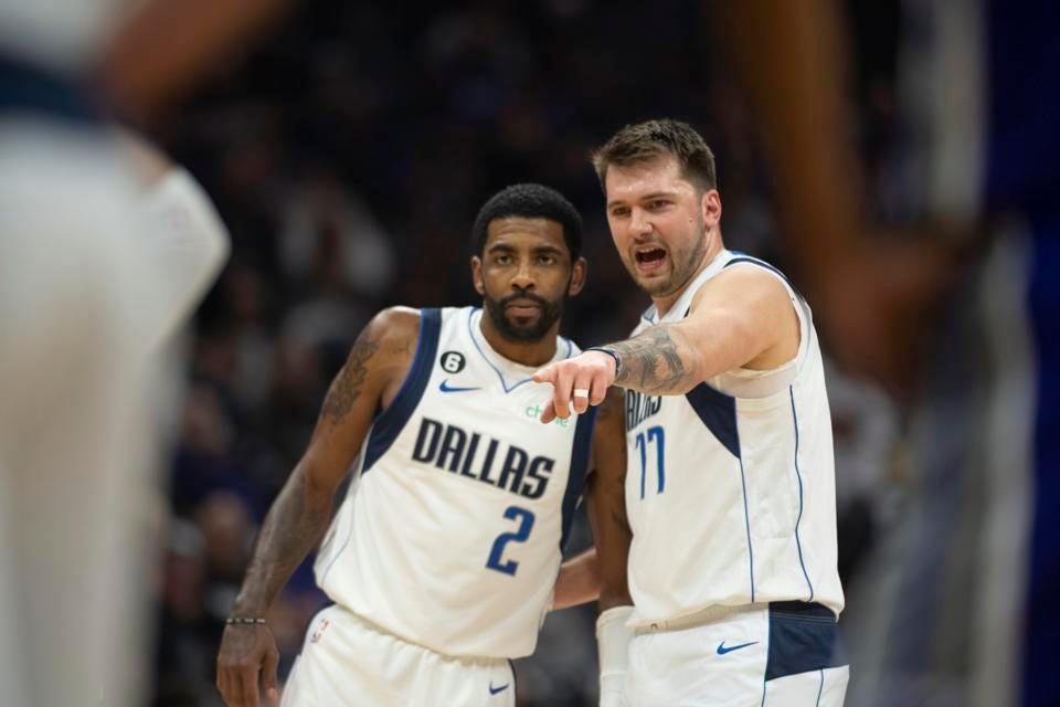  Dallas Mavericks guard Kyrie Irving (2) listens to guard Luka Doncic (77) in the first quarter of an NBA basketball game against the Sacramento Kings in Sacramento, Calif., Saturday, Feb. 11, 2023. (AP Photo/José Luis Villegas)  © 2023 The Associated Press 