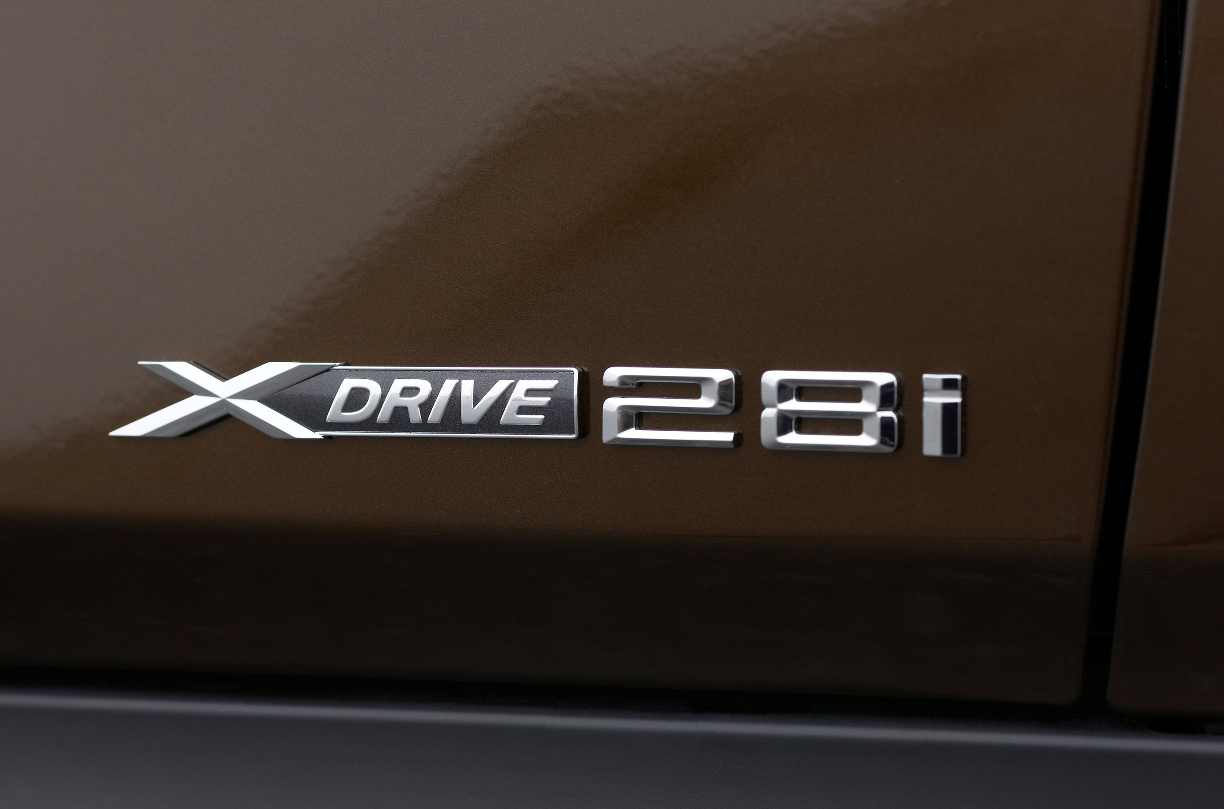 The badge above is from a BMW X1. Back in the 70s through the early 2000s, those two numbers would represent the engine displacement. However, the X1 does not have a 2.8-liter motor. It has a 2-liter motor. So what is this badge about? It's an homage to the days when base BMW motors were 2.8 liters . Somehow BMW thought that this number would matter to longtime brand loyalists. I don't think it does.